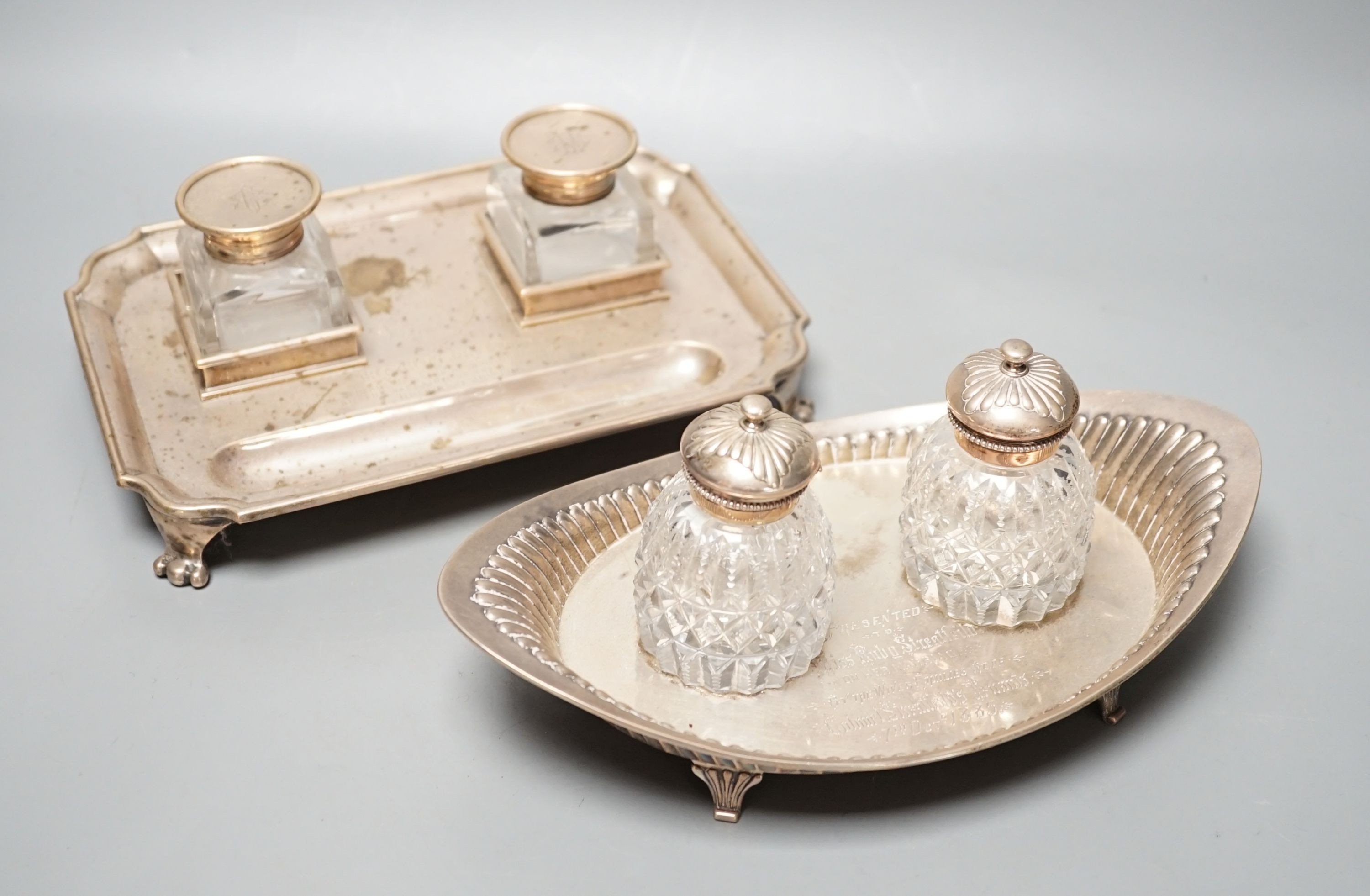 A presentation silver oval inkstand, with two mounted glass wells, William & John Barnard, London, 1884, ‘presented to Miss Ruby Streatfeild’, (a.f.),24.1cm and one other silver inkstand, Charles Stuart Harris, London, 1
